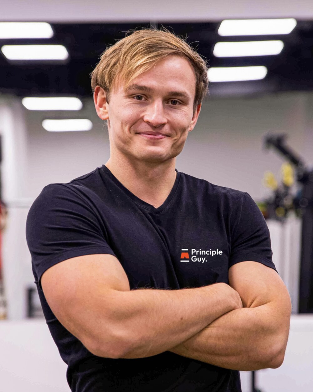 Erik Garaj in the gym, arms crossed